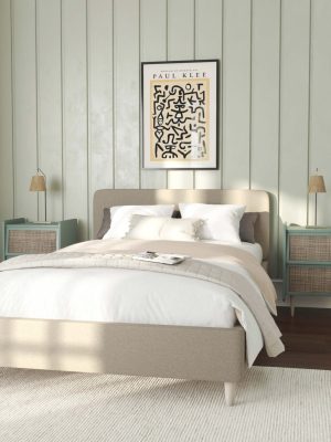 A neutral bedroom with careful additions of accent colour